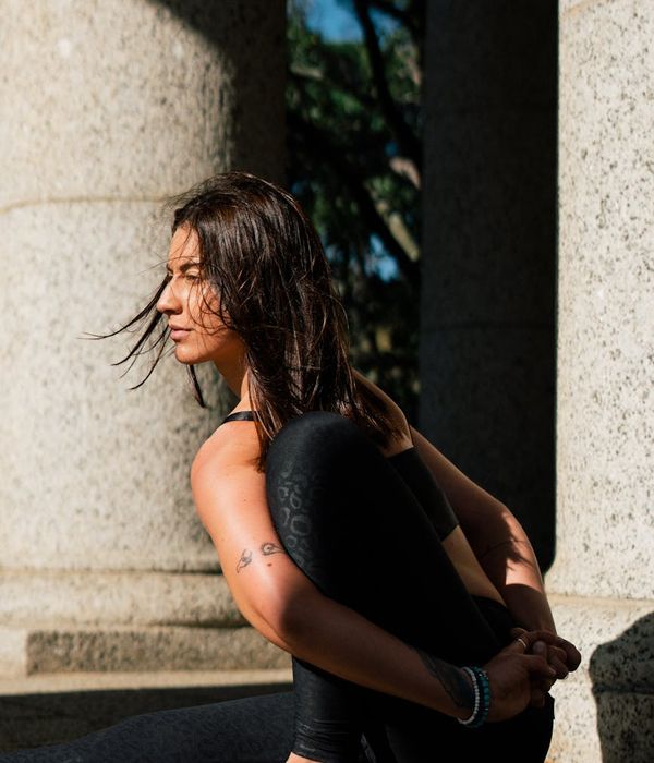 Person sitting calmly in a simple yoga posture.